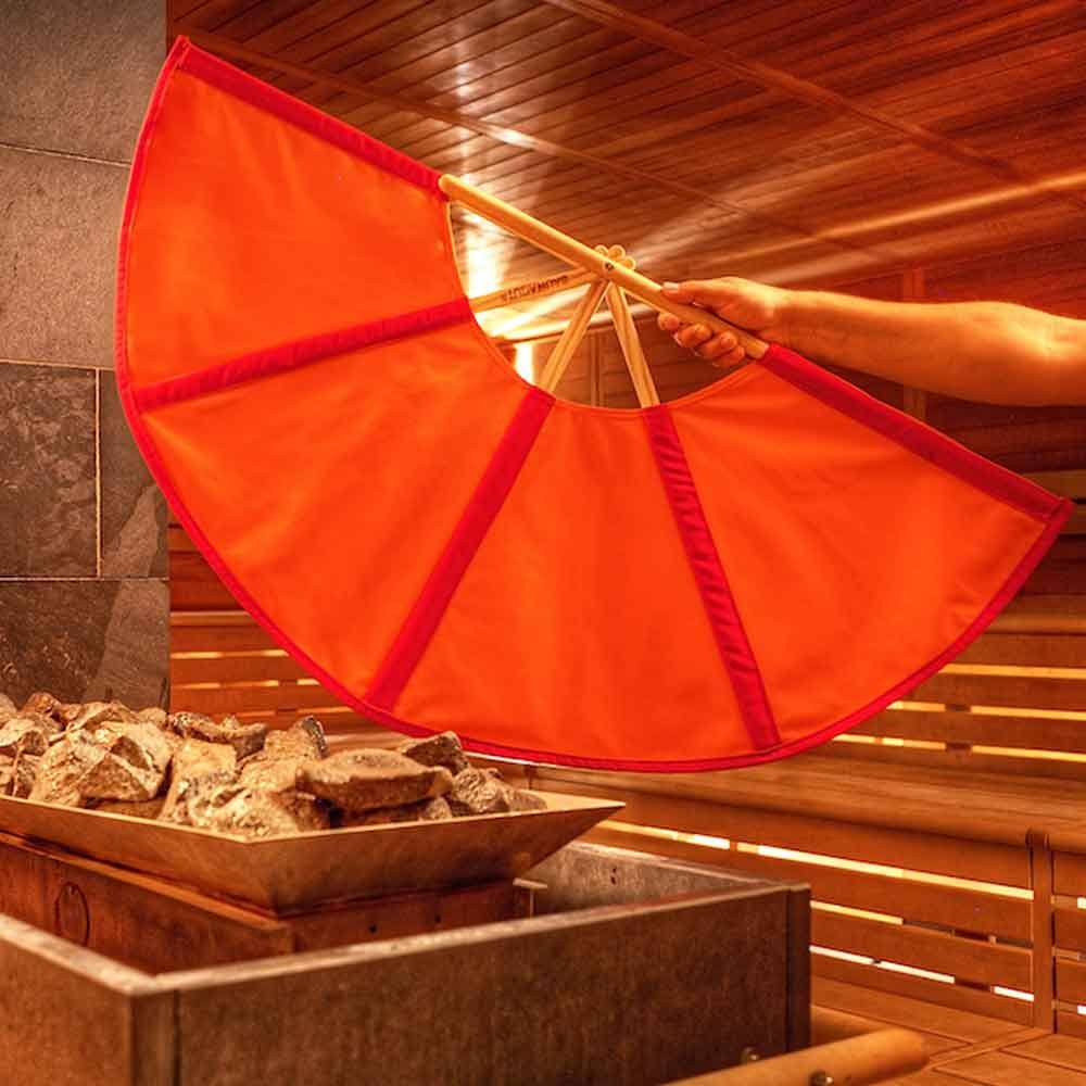 Sauna-Lüftungsgerät mit einem auf einem Holzrahmen gespannten orangefarbenen Stoff und Heizsteinen.
